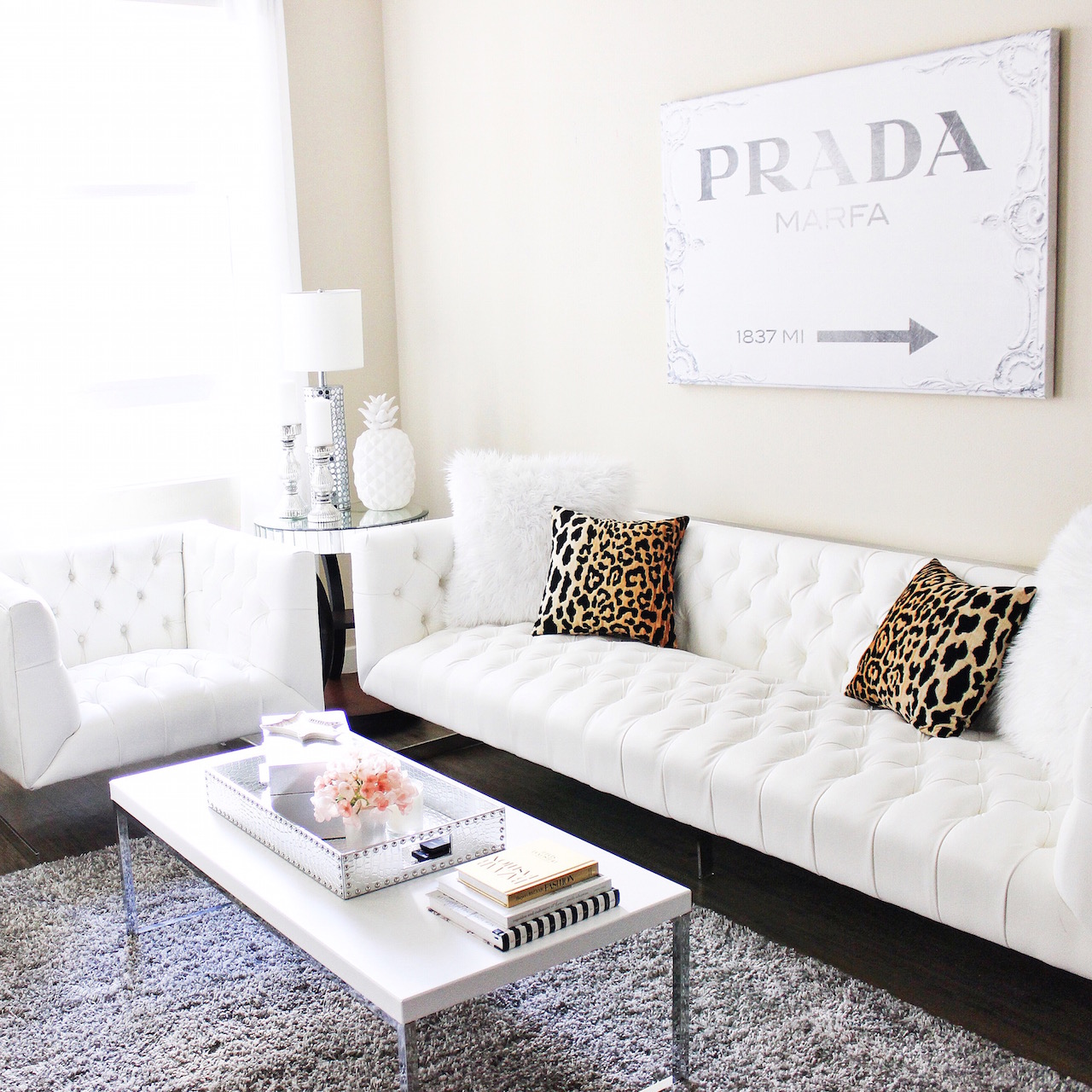 White Tuffed Couch | Leopard Pillows | Prada Canvas | White Living Room | StyledByBlondie.com
