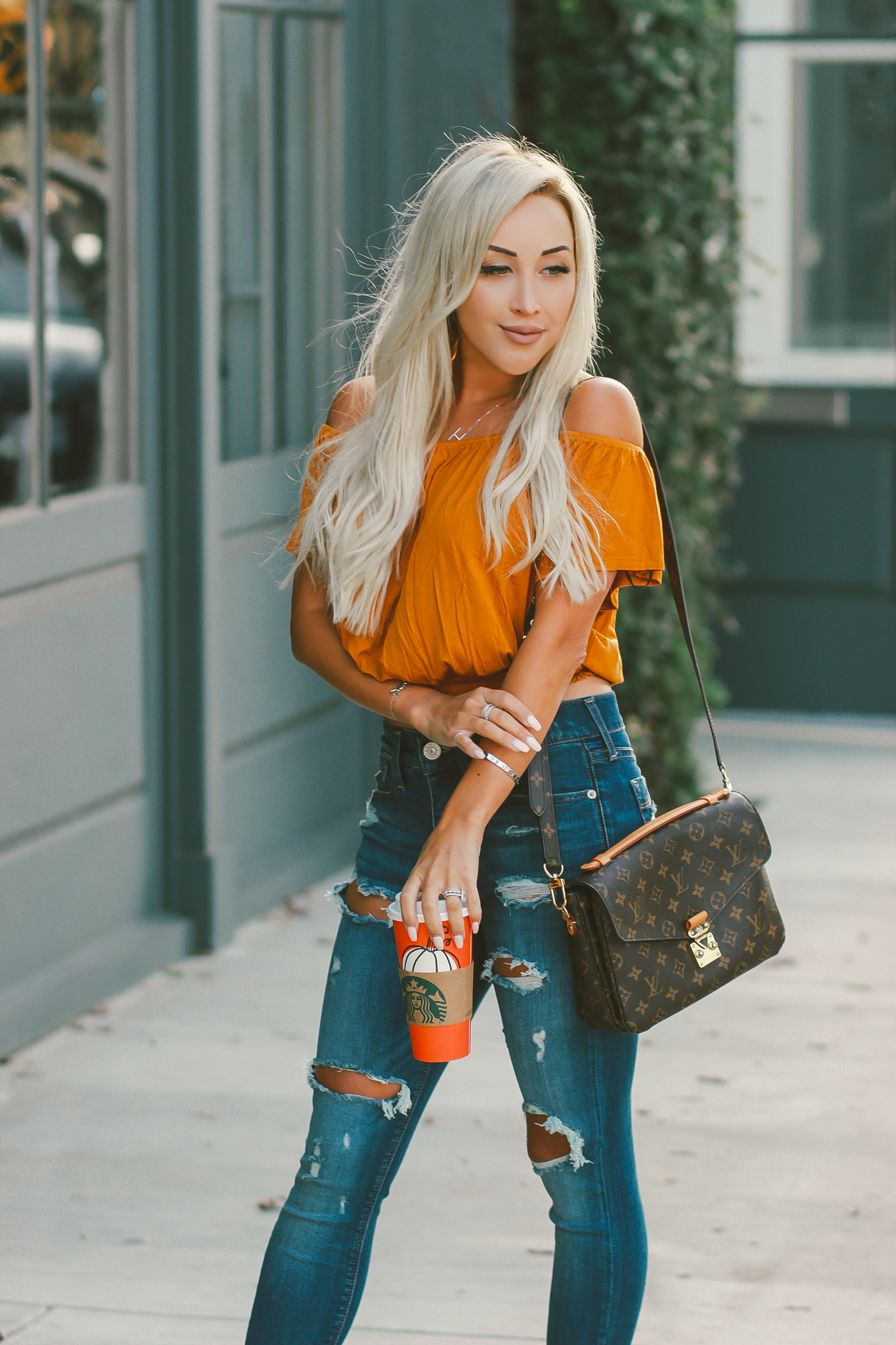Blondie in the City | Orange Off The Shoulder Crop Top | Distressed Jeans, Sam Edelman Heels | Louis Vuitton Pochette Metis | Fall Starbucks Cups