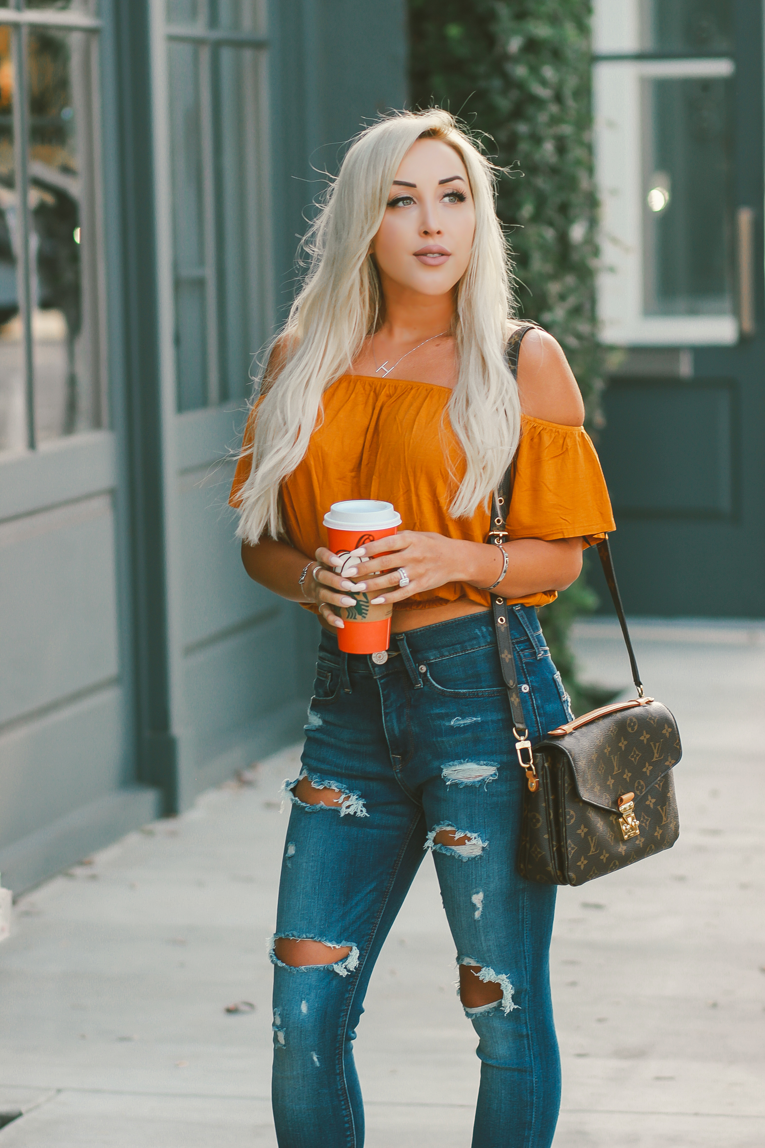 Blondie in the City | Orange Off The Shoulder Crop Top | Distressed Jeans, Sam Edelman Heels | Louis Vuitton Pochette Metis | Fall Starbucks Cups