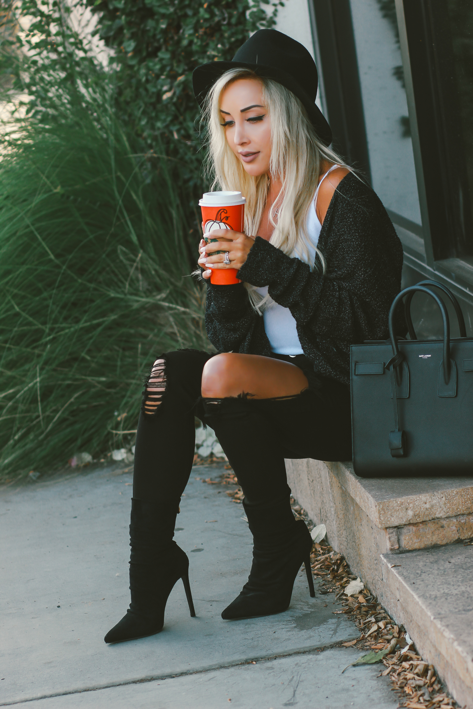 Blondie in the City | White bodysuit, black distressed jeans, black boots, black YSL Bag